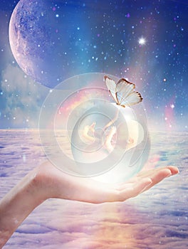 Cosmic womb, crystal ball with a baby inside, new born, star child, innocence, spiritual renewal, crystal children, indigo child