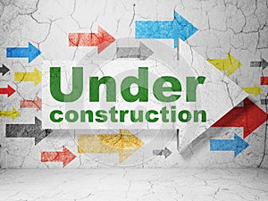 Web design concept: arrow with Under Construction on grunge wall background