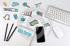 Web Design concept. Office desk table with computer, Smartphone, note pad, pencils