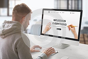 Web design studio with concept agency web page on computer display