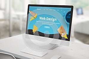 Web design studio concept with computer display on office desk and modern, flat web design studio presentation on screen with brus