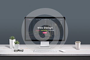 Web design studio concept. Work desk with computer display and modern design web agency page