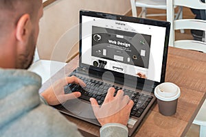 Web designer designs a modern flat website on a laptop
