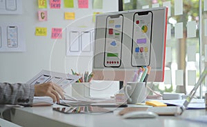 Web designer or developer planning application development draft sketch drawing template layout framework wireframe at design