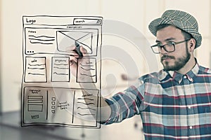 Web designer drawing website development wireframe at office