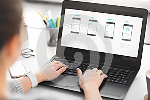 Web designer with laptop working on user interface