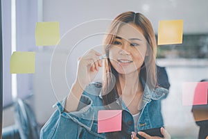 Web designers creating planning and analyzing with Colorful sticky notes on the office board.web design concept