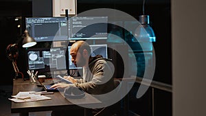 IT web developer comparing data files on clipboard papers