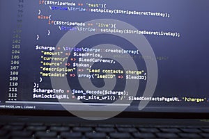 Web developer PHP code close up. Charging customer using Stripe API. Online payments processing