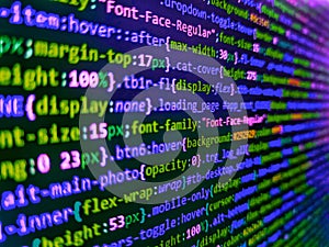 Web developer programmer monitor screen display. Program code PHP HTML CSS of site. Lines of code of a software with several