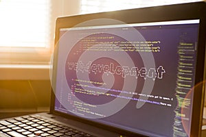 Web developer workplace in sunset lights. Web development phrase ASCII art inside real HTML code