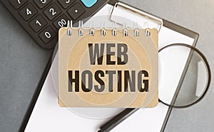 Web hosting business text concept. Text in notebook