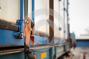 Webbing belt strap lashing to secure container load.