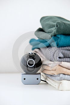 Webcam hidden in a stack of clothes for covert surveillance of the house.