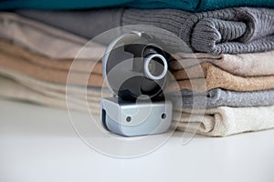 Webcam hidden in a stack of clothes for covert surveillance of the house.