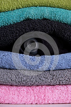 Webcam hidden in a stack of clothes for covert surveillance of the house.