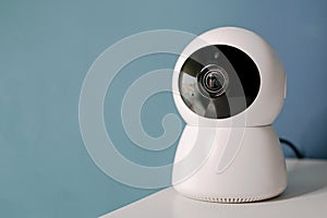 Webcam with white moving head with black protections covering the lens and infrared light bulbs for night lighting