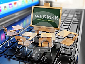 Webinar concept. Schooldesk and chalkboard on the laptop keyboard.