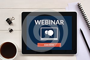 Webinar concept on tablet screen with office objects