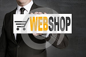 Webshop sign is held by businessman