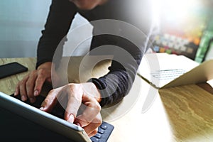 Website designer working digital tablet dock keyboard and computer laptop with smart phone and graphics design diagram on mable d