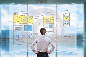 Website front end designer reviewing wireframe layout mockup, AR screen