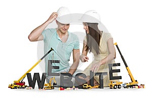 Website under construction: Friendly man and woman building webs