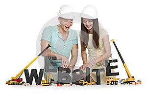 Website under construction: Joyful man and woman building website-word.