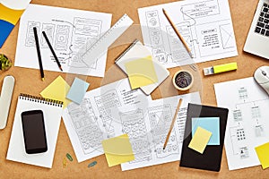 Website wireframe sketches over UX designers desk