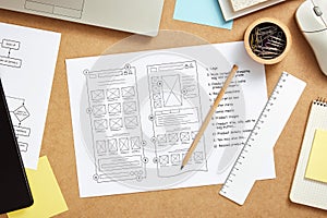 Website wireframe sketches over web designer desk