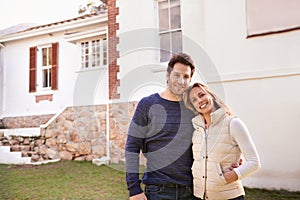 Wed always dreamed of owning a home, and now we do. A cropped view of a married couple standing in the front yard.