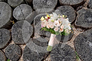 Wedd bouquet of peach roses and white orchids on stumps