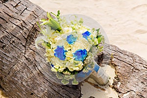 Wedding accessories. The bride's bouquet on a tropical beach.