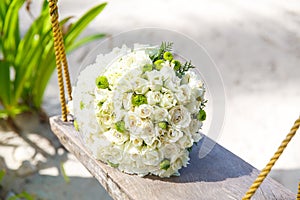 Wedding accessories. The bride's bouquet on a tropical beach.