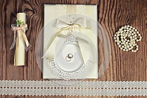 Wedding accessories and invitations to frame light wooden table