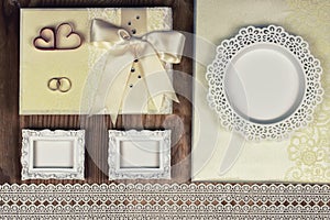 Wedding accessories and invitations to frame light wooden table