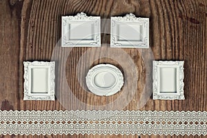 Wedding accessories and invitations to frame light wooden table