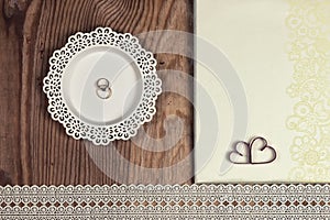 Wedding accessories and invitations to frame light wooden table