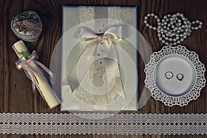 Wedding accessories and invitations to frame light wooden table