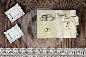 Wedding accessories and invitations to frame light wooden table