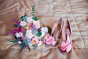 Wedding accessories for the morning of the bride in pink . Wedding bouquet and shoes of the bride.