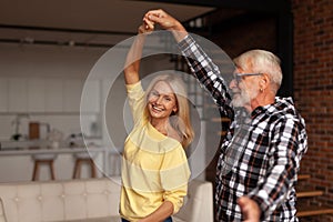 Wedding anniversary. Happy mature couple dancing at home. A romantic date with older people