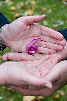 Wedding anniversary, a loving and married couple holding a number candle. Hands, wedding rings and candle close-up