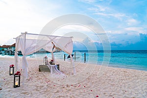wedding arch on beach with tropical Maldives resort and sea