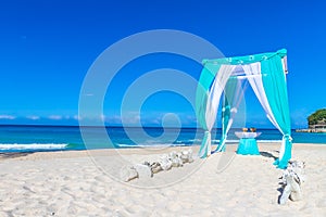 Wedding arch decorated with flowers on beach