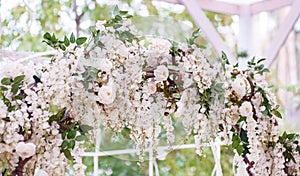 Wedding arch decorated with flowers. Beautiful wedding decor