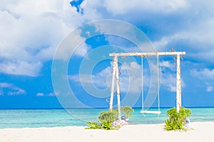 Wedding arch decorated with flowers on tropical beach, outd