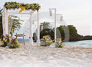 wedding arch - tent - decorated with flowers on beach, tropical wedding ceremony set up