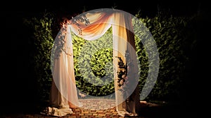 Wedding arch with illuminated light bulbs in the evening