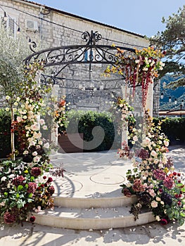 Wedding arch-rotunda near the building in the garden